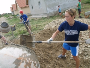 Sarah Taylor shows her LMU pride on the job for Habitat for Humanity in Romania.